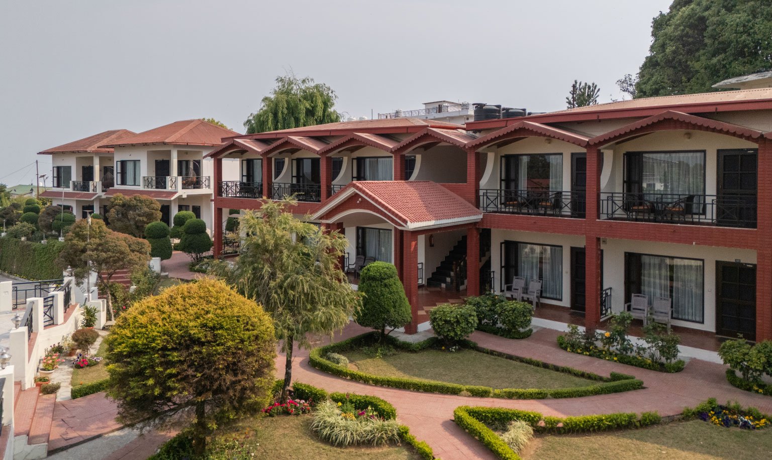 Contact Ojaswi Himalayan Resort Mukteshwar for bookings and inquiries, featuring scenic mountain views and luxury hospitality.