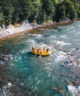A guest relaxing at the edge of the infinity pool at Ojaswi Resort, taking in the expansive mountain landscape.