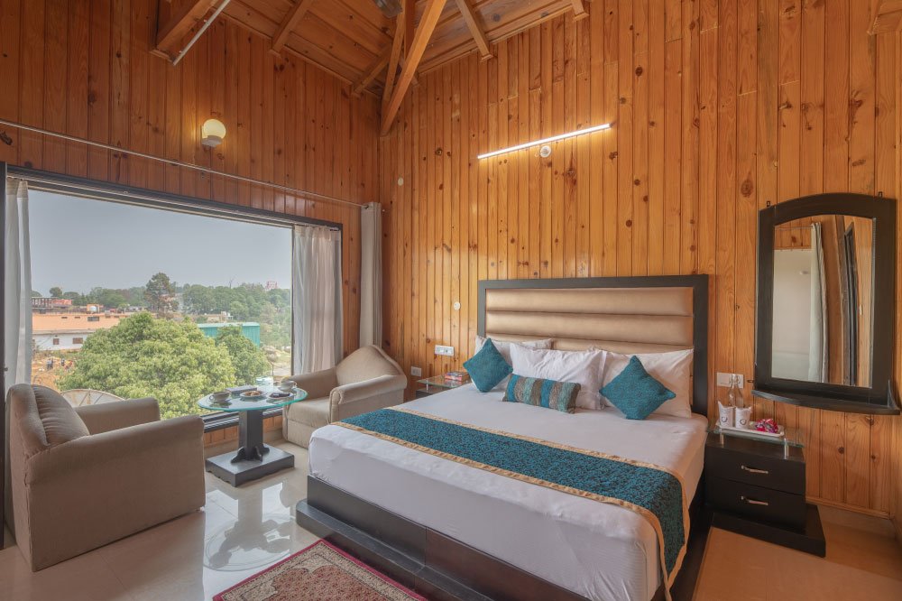 Buransh Retreat room at Ojaswi Himalayan Resort Mukteshwar with warm wooden interiors and mountain views