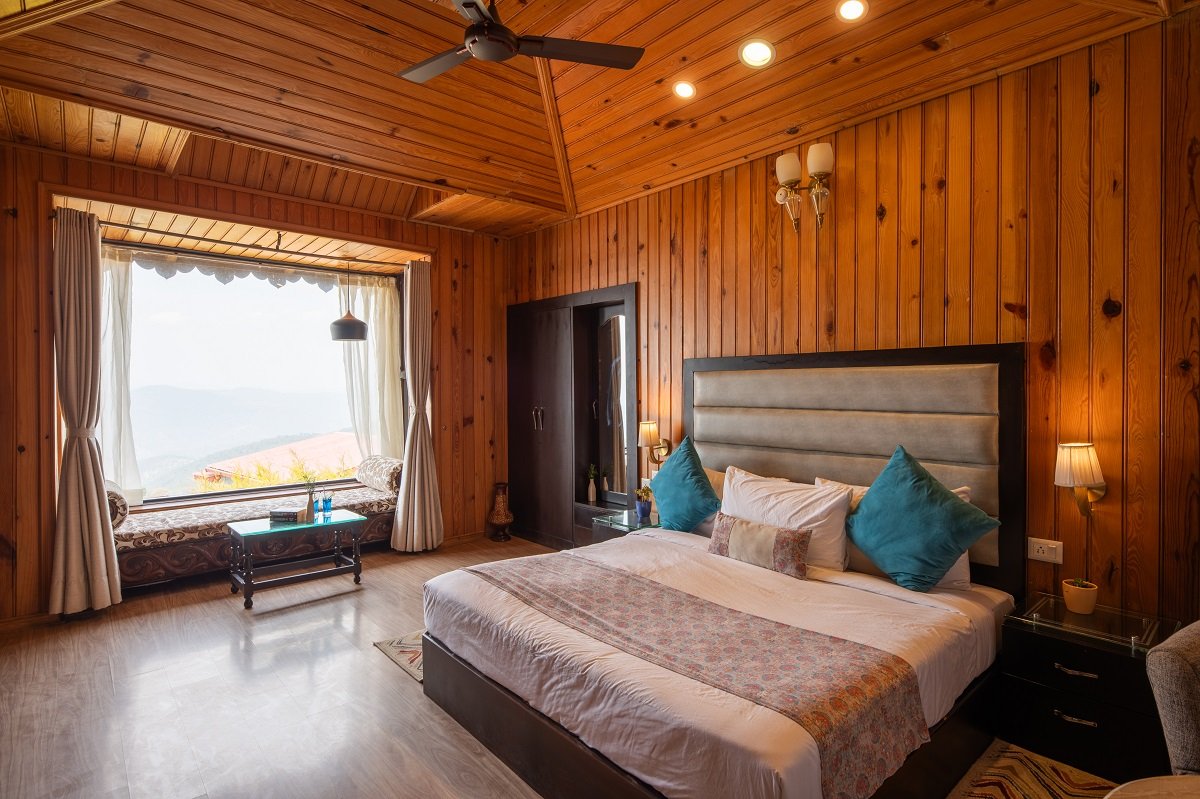 Himalayan Suite at Ojaswi Resort Mukteshwar featuring traditional decor and warm wooden interiors.
